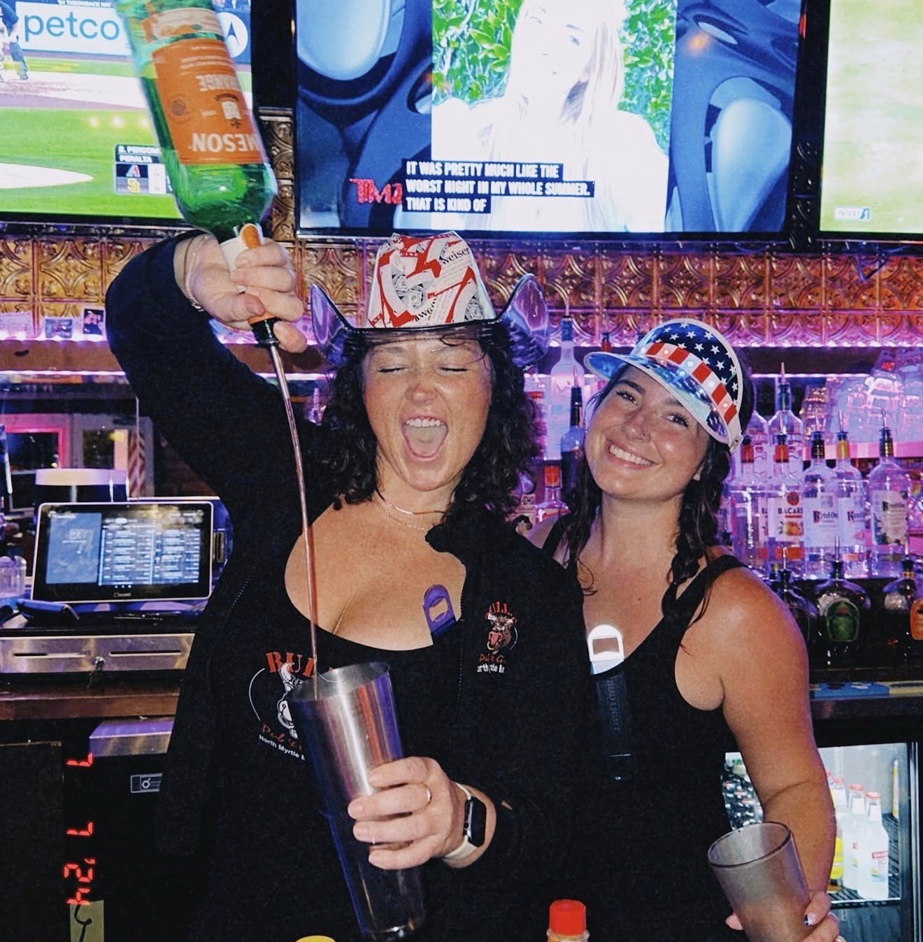 Two Bully's bartenders pouring at the bar