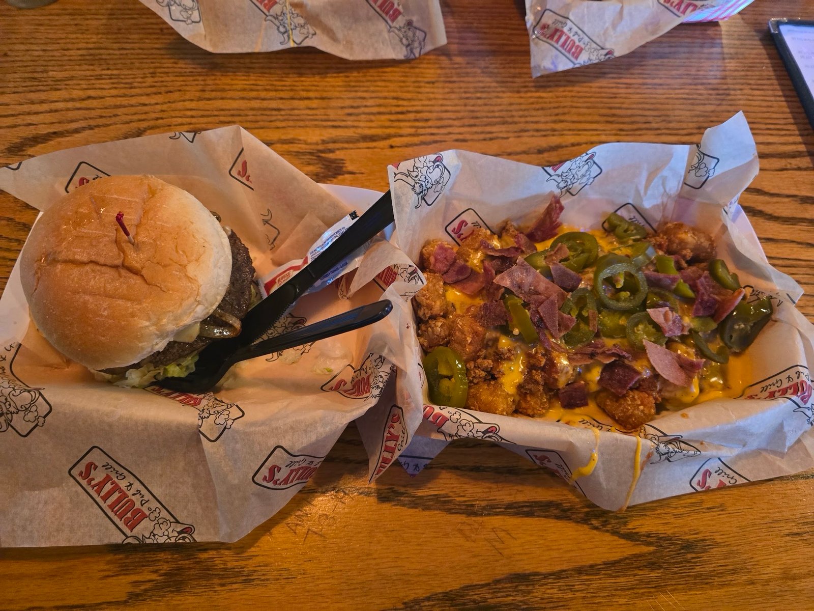 A burger and Totchos in Bully's baskets