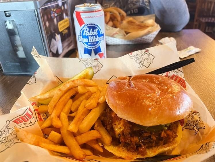 A burger and fries in Bully's paper with a PBR