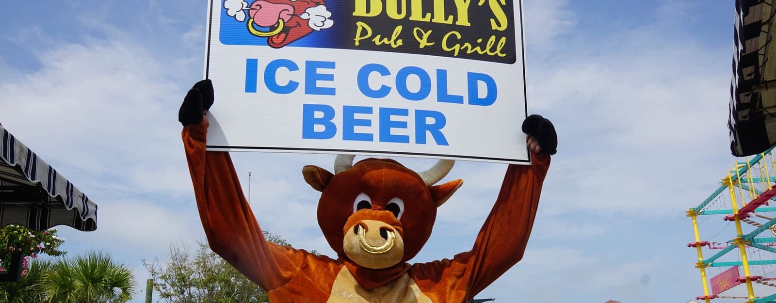 The Bully's bull mascot holding an Ice Cold Beer sign at Barefoot Landing