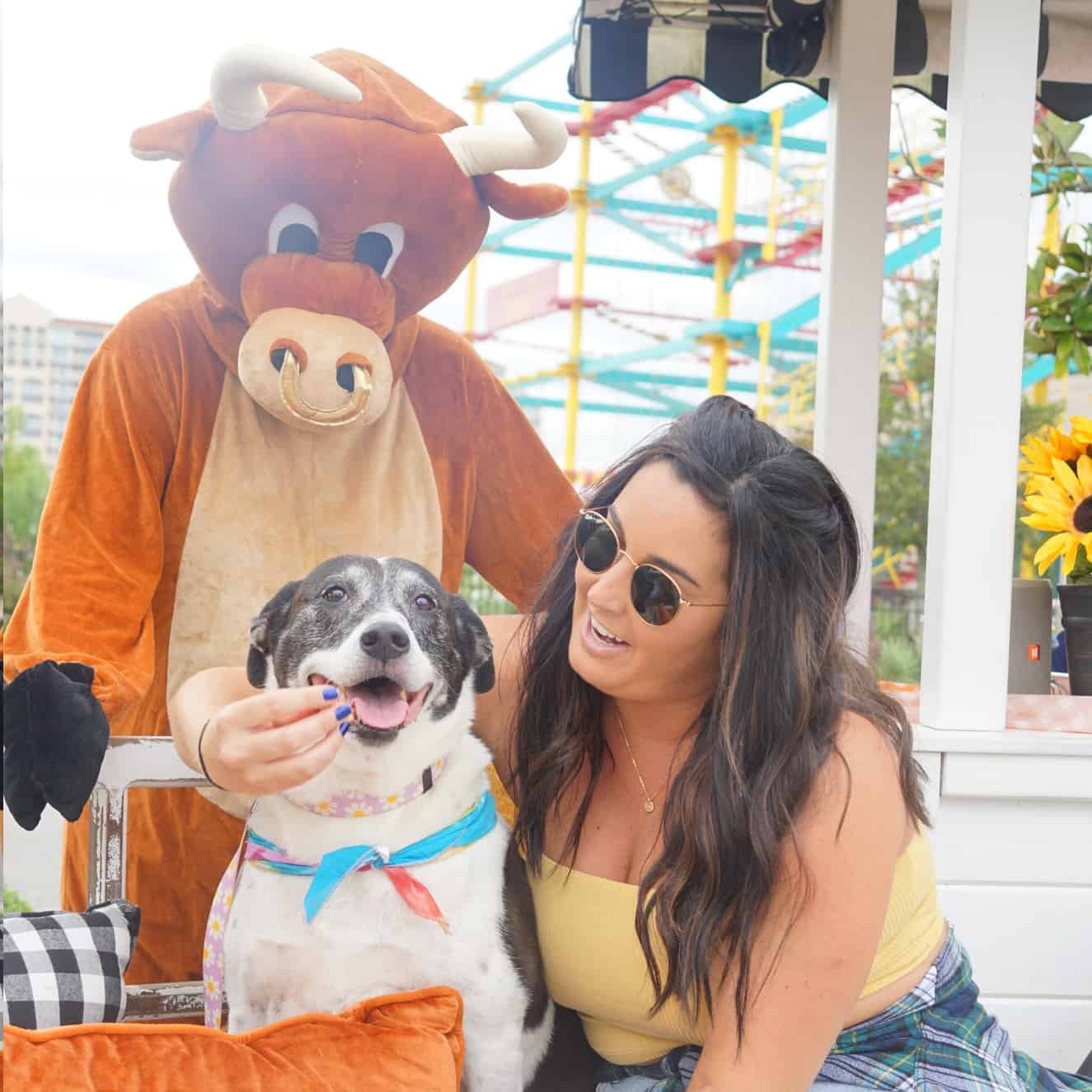 The Bully mascot with a guest and her dog on the porch
